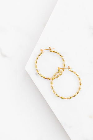 Find the perfect pair of earrings you're looking for from Charme Silkiner! These antiqued gold spiral hoop earrings are seriously stunning. Perfect to dress or dress down any outfit the Salem Earrings are the perfect must have for everyone!