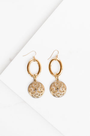 Find the perfect pair of earrings you're looking for from Charme Silkiner! These 24k gold overlay hoop earrings with a gold medallion coin are seriously stunning. Perfect to dress or dress down any outfit the Gianna Earrings are the perfect must have for everyone!