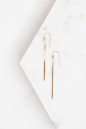 Find the perfect pair of earrings you're looking for from Charme Silkiner! These gold and CZ bezel drop earrings are stunning with their narrow bar and CZ accents. Perfect to dress or dress down any outfit the Vanna Earrings are the perfect must have for everyone!
